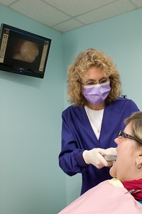 Hygienist taking an intraoral photo of a patient's tooth