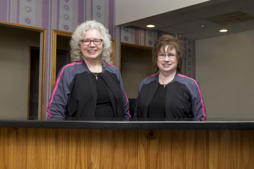 Dr. Maron's administrative team standing behind the reception desk