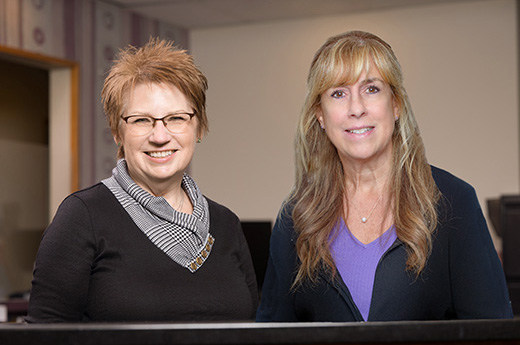 Dr. Maron's administrative team standing behind the reception desk