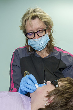 Hygienist doing a dental cleaning on a patient at Dr. Maron's office