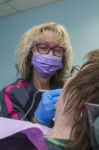 Hygienist taking an intraoral photo of a patient's mouth