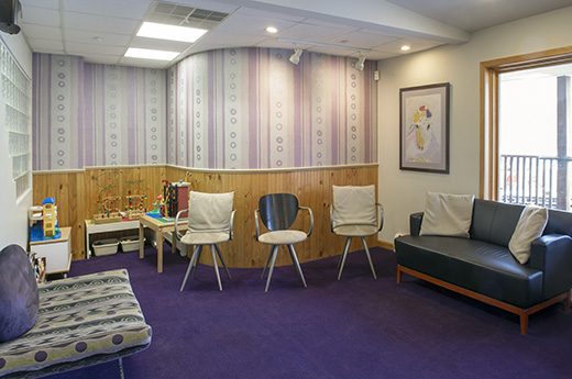 Dr. Maron's Poughkeepsie dental office waiting room with natural lighting, contemporary furnishings, and a children's corner
